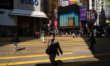 Covid: Sweden ‘should have clamped down harder’ as pandemic hit; US set to ease mask guidelines – as it happened 5 A man wearing a face mask walks across a street In Causeway Bay, a shopping district of Hong Kong.