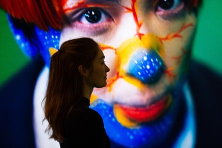 A flaming world... gallery assistant poses with Sin Wai Kin's A Dream of Wholeness in Parts at Tate Liverpool.