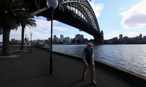 A person is seen exercising in the early morning under the Sydney Harbour Bridge, Sydney, Australia.