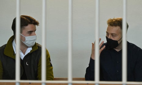 two young men behind bars