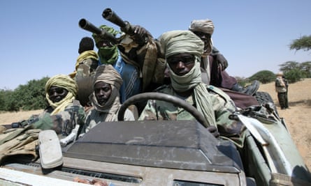 Fighters drive an armoured truck near the Sudan-Chad border.