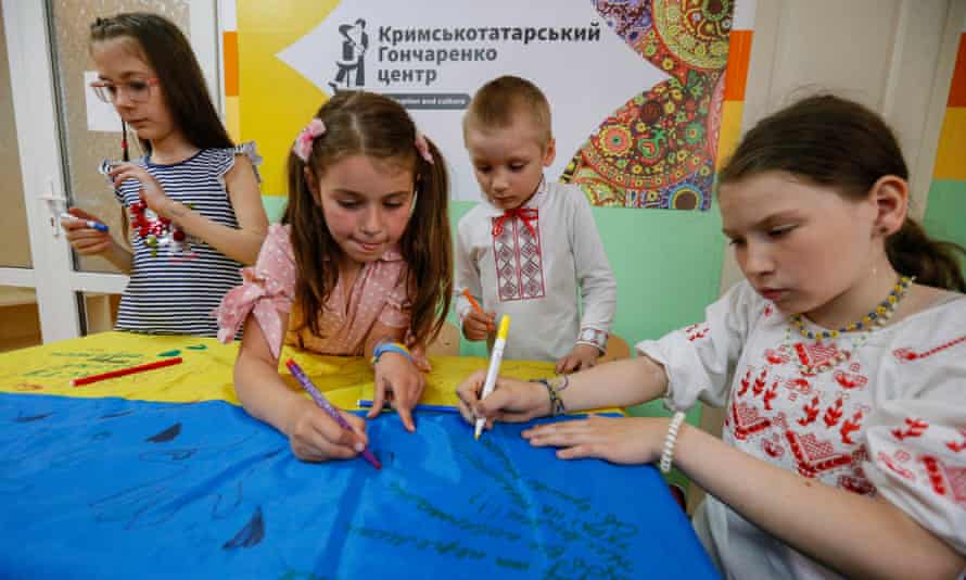 Local children sign a Ukraine flag in Odesa, which will be handed to their country’s service personnel as a gesture of support.