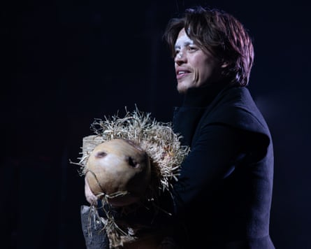 Colin Ryan carries a scarecrow in Martin Guerre
