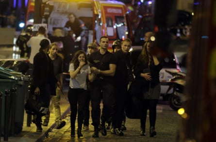 Rescuers evacuate people following an attack at the Bataclan bar in Paris, 13 November 2015.