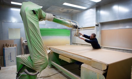 A worker uses a machine at Crystal Doors