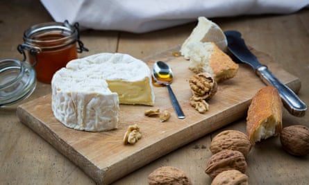 Camembert, bread, walnuts and honey on wood