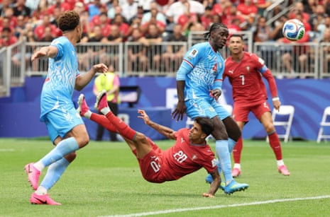 DR Congo's Axel Tuanzebe fails to block the ball as Portugal's Joao Cancelo fires an overhead volley home but it's chalked off for offside.