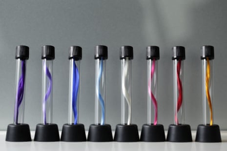 Strands of different coloured silk yarn in test tubes.