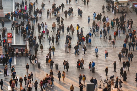 A busy pedestrian crowd at Piazza del Duomo in Milan, Italy