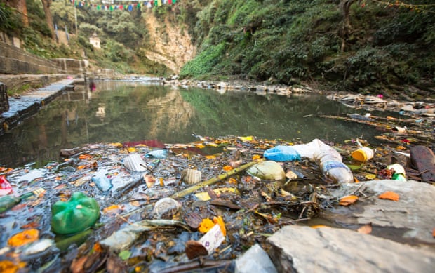 Garbage and bottles floating on waterPlastic Contamination into Nature. Environmental pollution in the Himalayas. Garbage in the water of river Bagmati.