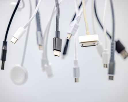Old 30 pin connectors, USB and lightning cables hanging down against a white background.
