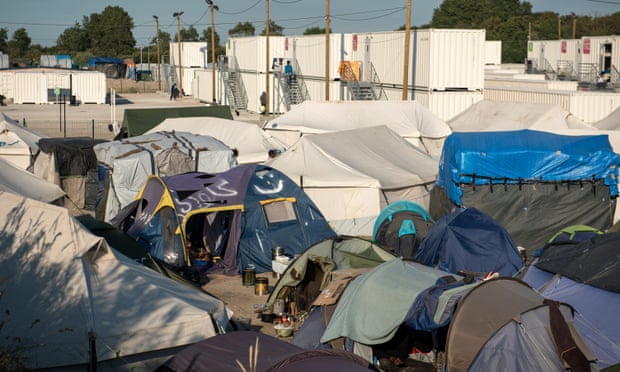 The tents and white metal containers housing refugees in Calais.