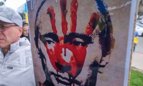 poster of Vladimir Putin with a red handprint on his face