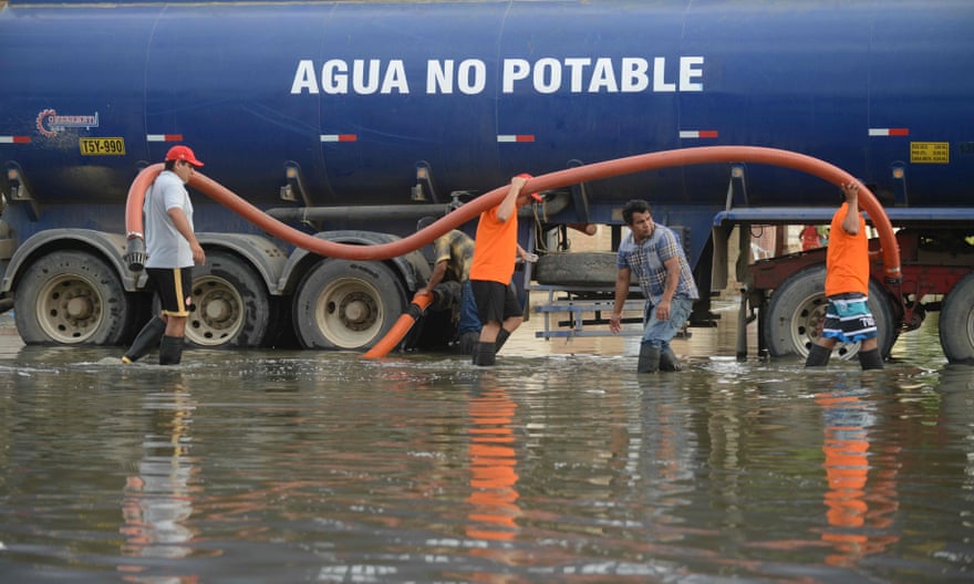 Municipal workers use a water truck to remove stagnant water from a neighbourhood in Chiclayo, Peru