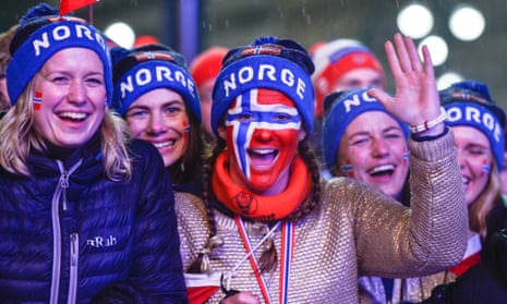 Norwegian fans celebrate their team’s gold medal in the men's cross-country relay