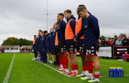 Players observe a minute’s silence in memory of Billy Vigar at the National League match between Truro City and Morecambe at Truro City Stadium on 27 September 2025.