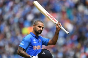 Dhawan raises his bat as he receives a standing ovation from the crowd as he walks back to the pavilion after his dismissal.