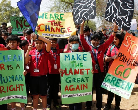 Students hold placards as they take part in a global protest against climate change
