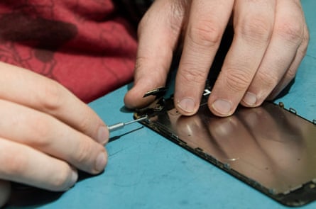 close up of a man fixing a smartphone