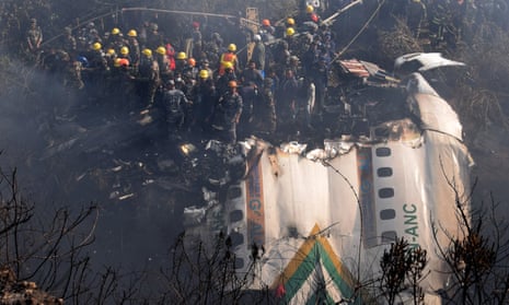 Rescue teams working near the wreckage at the crash site of a Yeti Airlines ATR72 aircraft in Pokhara, central Nepal