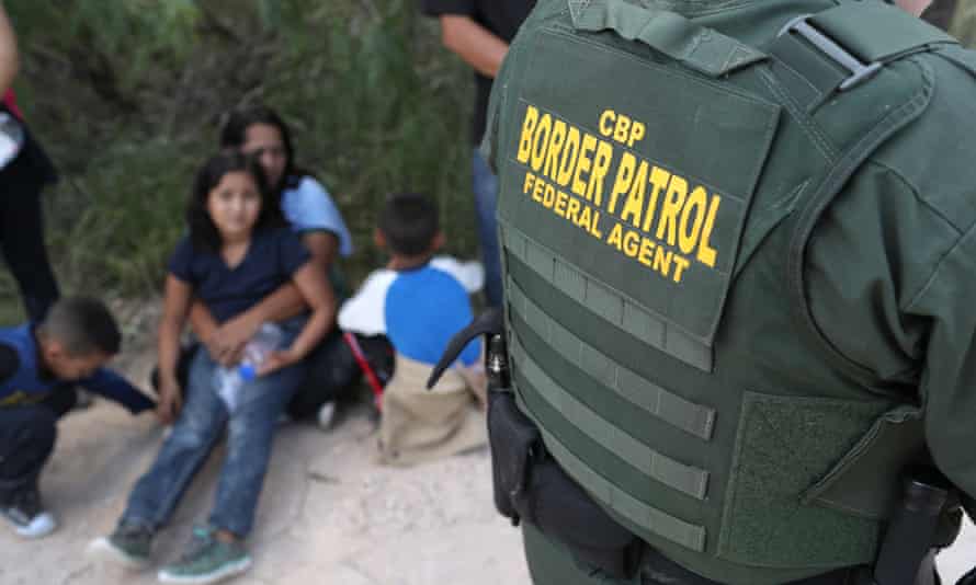 Central American asylum seekers wait as US Border Patrol agents take them into custody this month near McAllen, Texas.