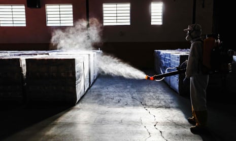 An employee disinfects supplies at a municipal warehouse in Curitiba, Brazil on 19 June 2020. The country now has more than 1 million confirmed cases of Covid-19.
