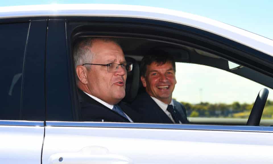 Scott Morrison and Angus Taylor in an electric vehicle