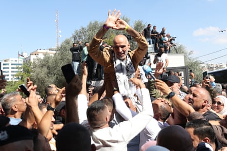 A freed Palestinian man is greeted as prisoners arrive after being released from an Israeli jail in the West Bank city of Ramallah.
