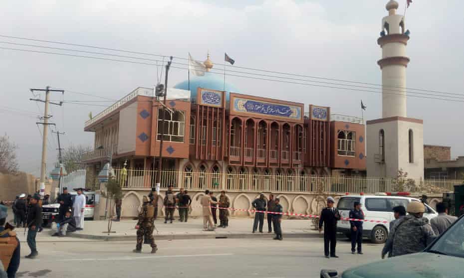 Afghan security forces keep watch in front of the mosque in Kabul after the bomb attack