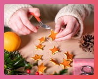 Close up of a woman making eco-friendly Christmas decorations from orange peel