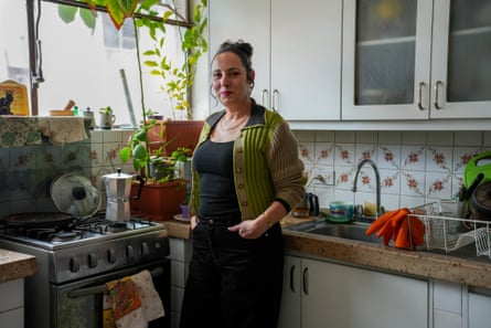 A middle-aged woman stands in a kitchen