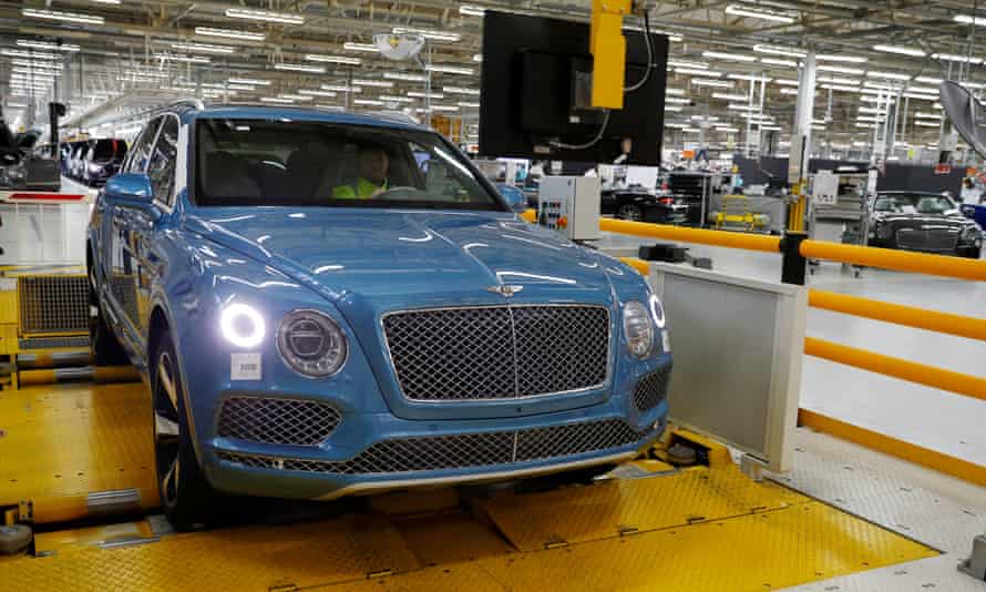 A worker drives a Bentley SUV on a rolling road at the factory in Crewe.