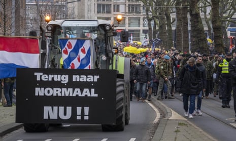 A sign on a tractor reads ‘Back to normal now’ as thousands of people march through Amsterdam in protest against the Dutch government’s coronavirus lockdown measures.