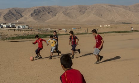 Yazidi boys play football at a camp in Sharya, Iraq