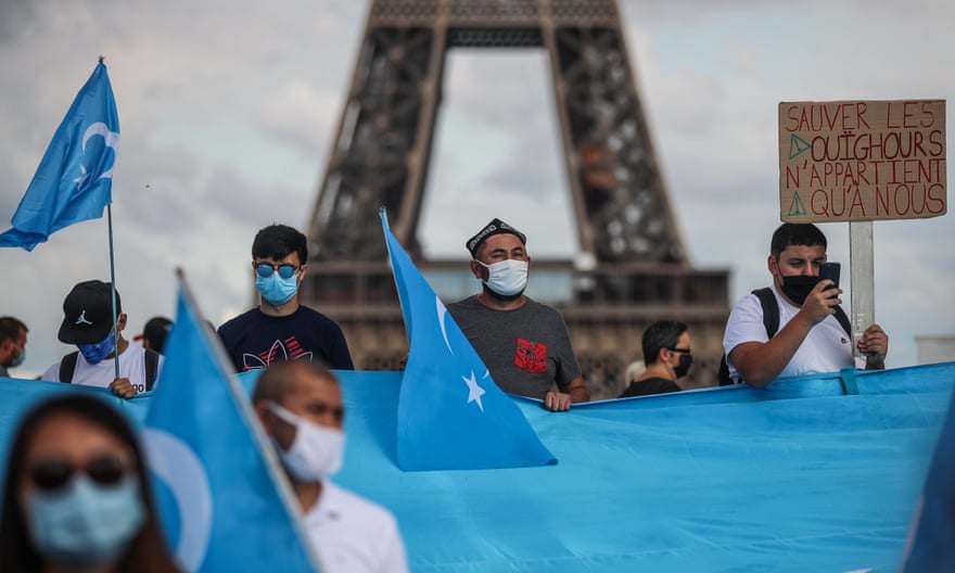 Members of the Uighur community and supporters demonstrate near the Eiffel Tower in Paris in 2020.