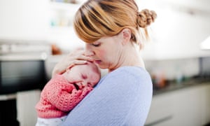 Mother holding newborn daughter