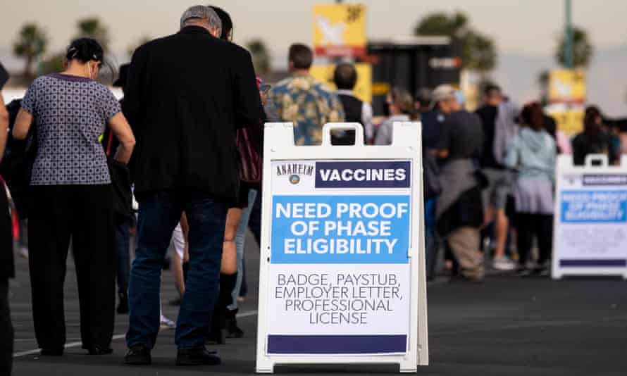 People are queuing up waiting to be vaccinated against Covid-19 in a parking lot at Disneyland in Anaheim, California.