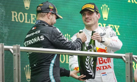 Mercedes’ Valtteri Bottas celebrates on the podium with drivers’ championship leader Max Verstappen of Red Bull.
