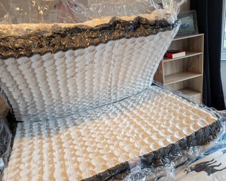 An Emma mattress still in its plastic wrap is expanding
