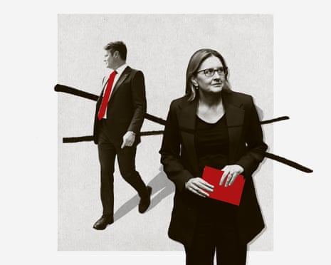Ben Carroll in a suit with red tie walks away while Jacinta Allan in glasses holds red folders