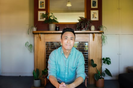 Chris Tse seated in a loungeroom with fireplace and potplants in the background