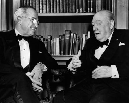B/w image of Truman and Churchill sat in front of bookshelf, in discussion