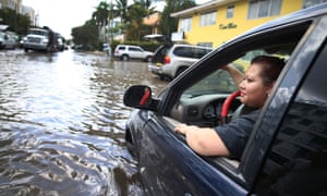 Sandy Garcia sits in her vehicle that was stuck in a flooded street in Fort Lauderdale, Florida. South Florida is among the most vulnerable regions in America to climate change impacts.