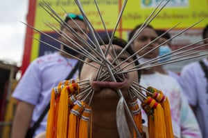 Thai devotees are possessed by spirits and pierced with long needles during a vegetarian ritual at the Sapam Shrine in Phuket, Thailand