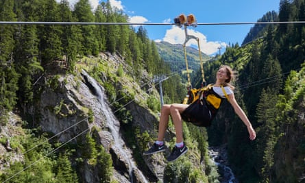 A woman riding the Skyfly Ischgl zipwire, which operates all year.