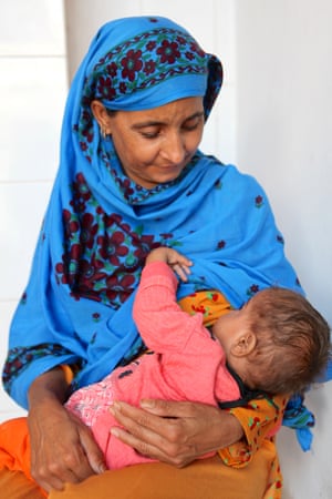 Samina Bibi breastfeeds her daughter, 18-month-old Afsana