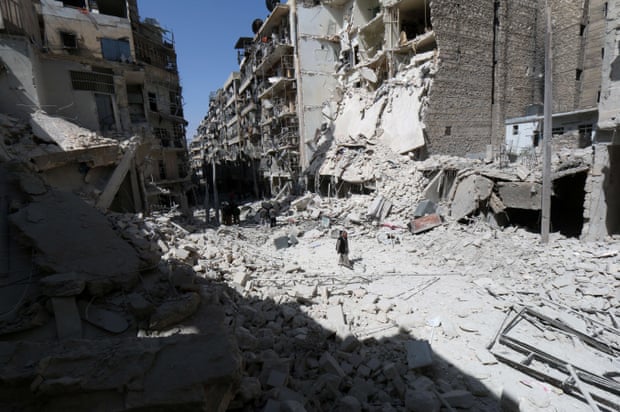 A man walks through the rubble following air strikes by government forces on the eastern Shaar neighbourhood of the northern Syrian city of Aleppo in March 2015.