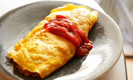 Omurice served with tomato sauce.