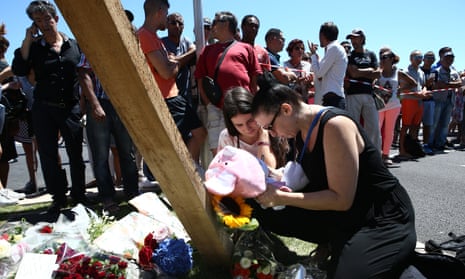 Flowers and soft toys are left near the site where a truck rammed into a crowd of revellers celebrating Bastille Day, killing at least 84 people.