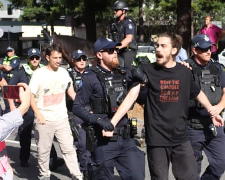 Zac Karaniki (right) and William Sim (in white T-shirt) are arrested at a pro-Palestinian protest